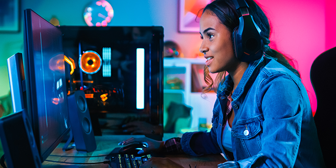 A young woman playing video game on a PC